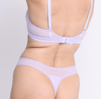 Size XS model showing back view of lilac haze mid rise thong in organic cotton fabric 
Sexy high cut leg, non-toxic lace trim, breathable cotton fabric