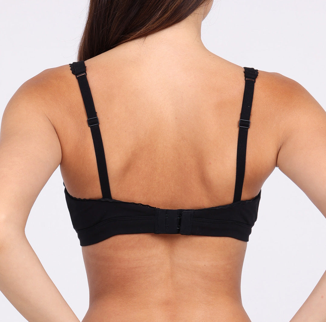 Size X-small Woman showing back view of certified organic cotton bralette with lace detail and adjustable closure and straps