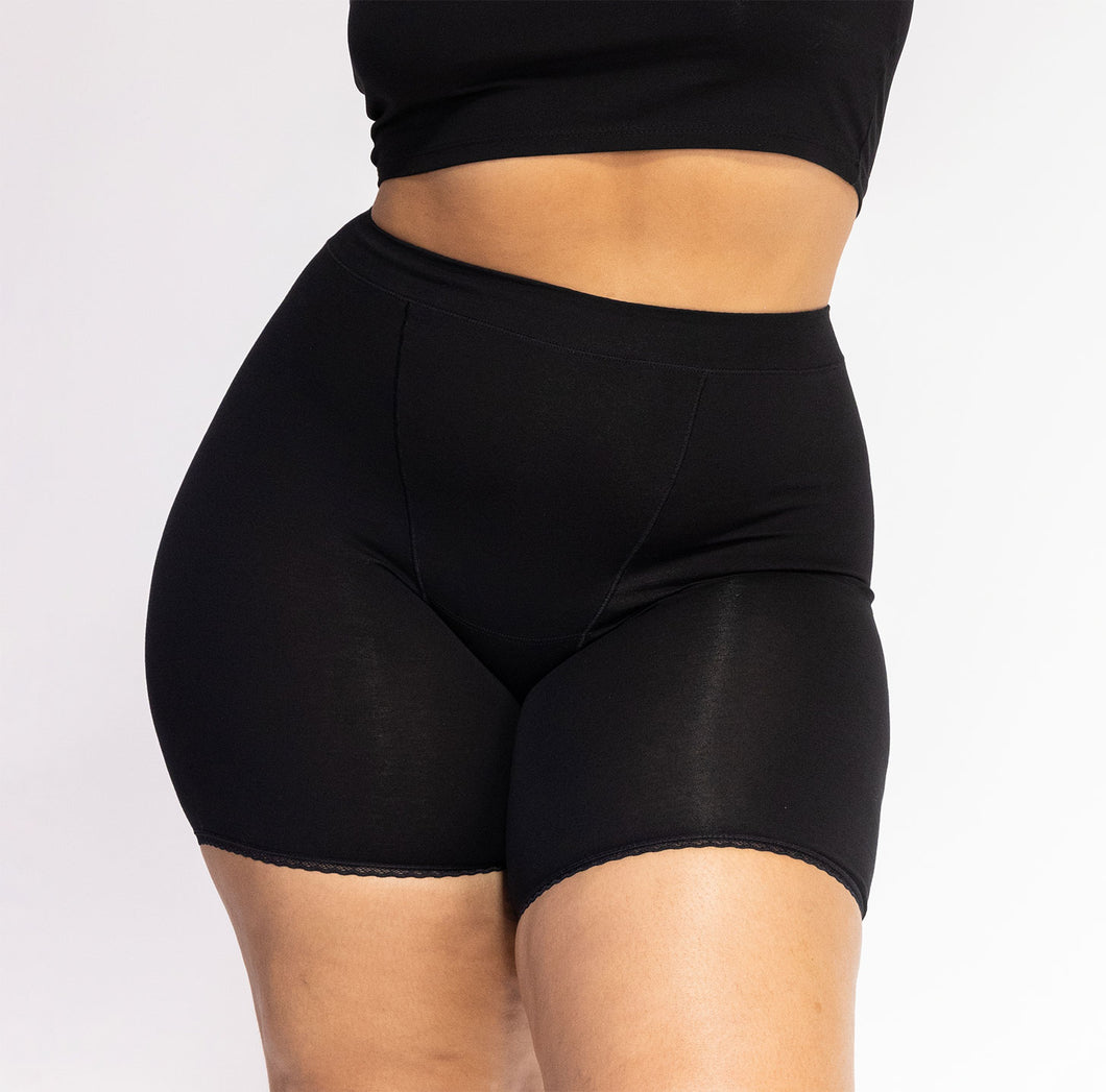 Woman wearing la coochie high rise organic cotton boxer for women in midnight black