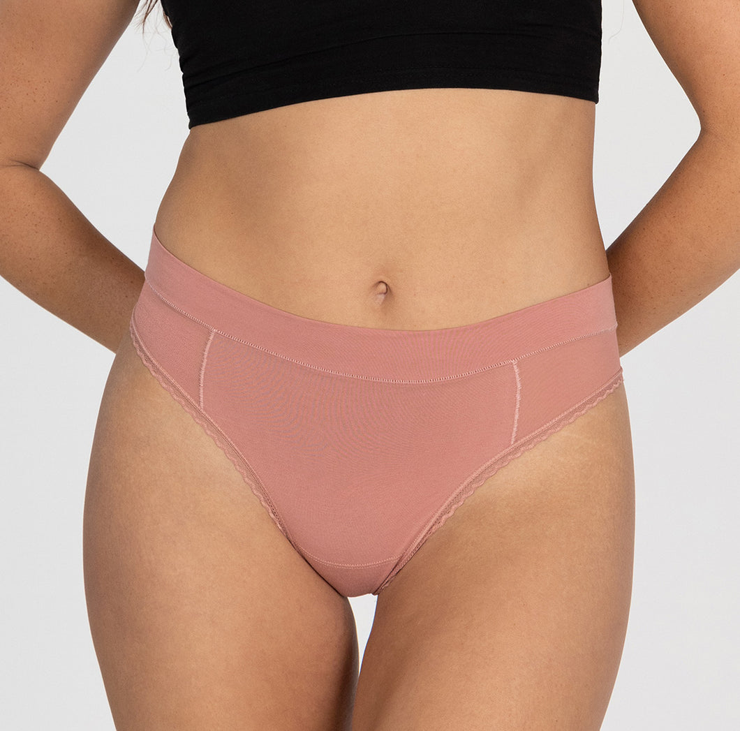 Front view of woman wearing high waisted thong in organic cotton fabric, featuring all-cotton style in desert rose pink