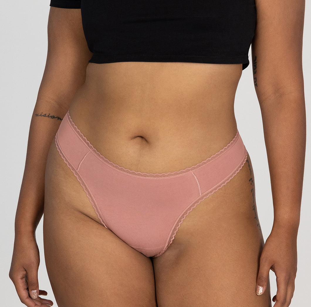 model wearing desert rose all organic cotton mid rise brief style in desert rose pink color. Ultra-soft fabric and lightweight style.